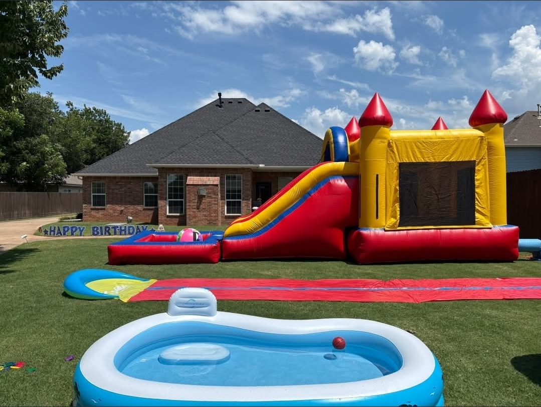 Real Caring Hands event setup with inflatable water slide